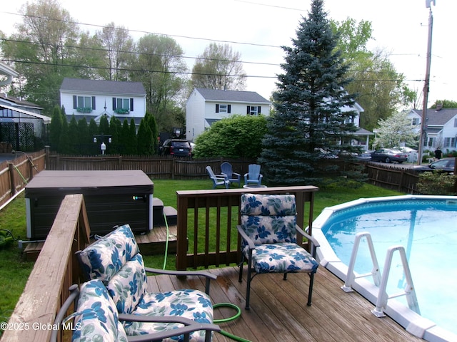 outdoor pool featuring a fenced backyard and a wooden deck