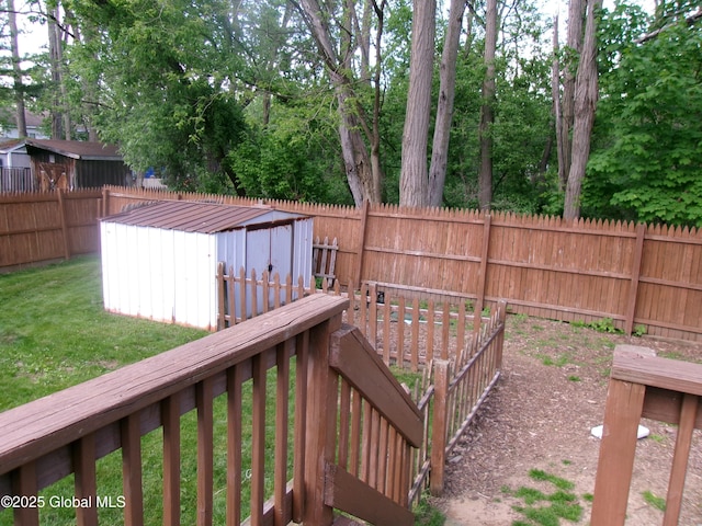 wooden terrace featuring a storage unit and an outbuilding