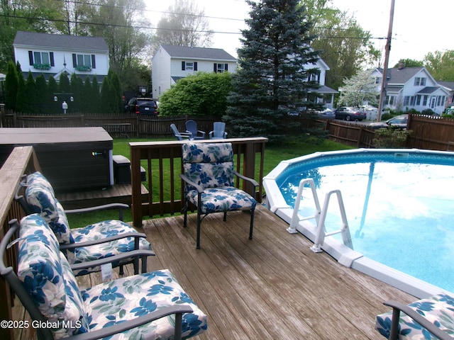 view of swimming pool featuring a deck and a residential view