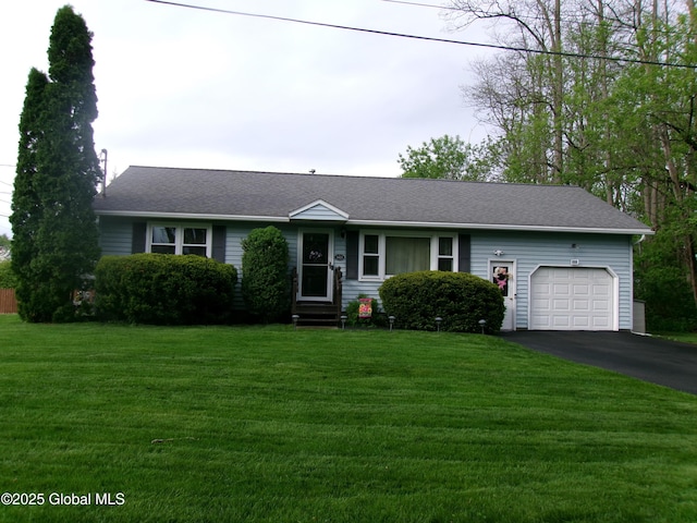 view of front facade featuring driveway, an attached garage, a front yard, and entry steps