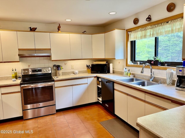 kitchen with black appliances, under cabinet range hood, a sink, light countertops, and recessed lighting
