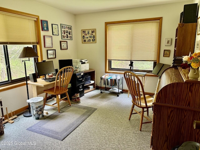 carpeted home office featuring baseboards