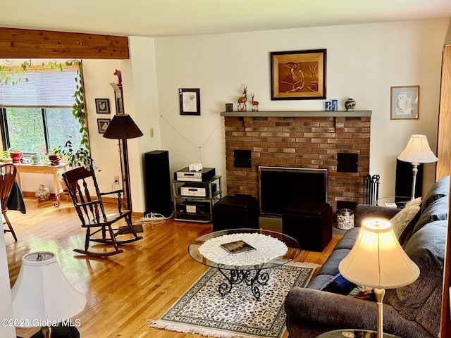 living area featuring light wood finished floors and a fireplace