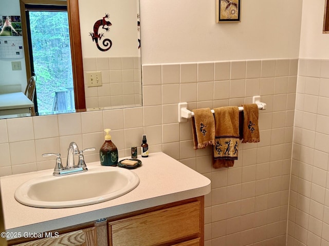 bathroom with vanity and tile walls