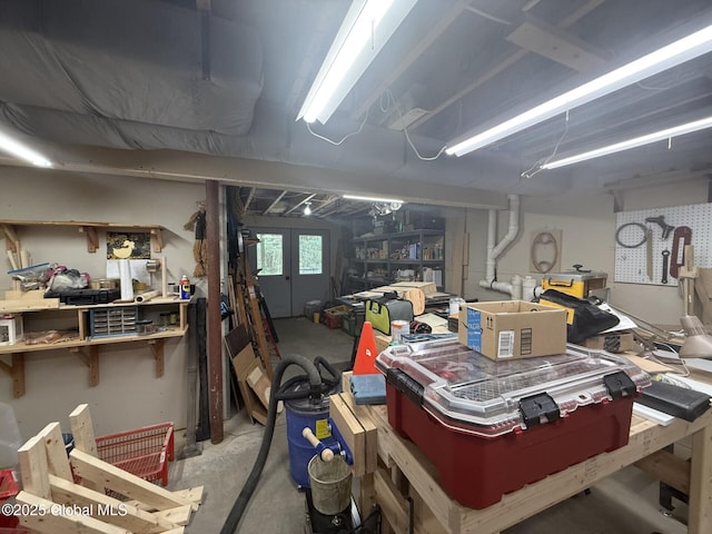 garage with a workshop area and french doors