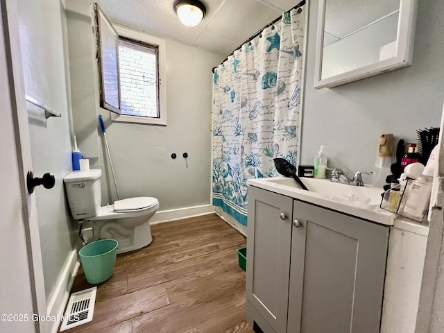 327 9th St, Troy, NY 12180 - bathroom with toilet, wood finished floors, a shower with curtain, vanity, and baseboards