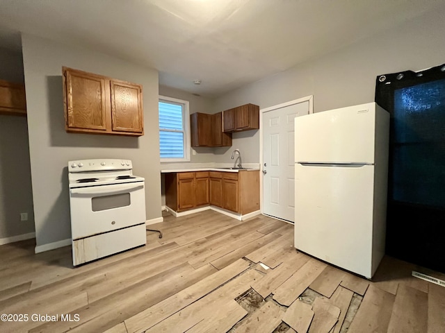 254 2nd St, Albany, NY 12206 - kitchen with white appliances, light wood-style floors, light countertops, and brown cabinets