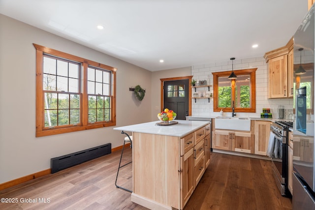 kitchen featuring a sink, stainless steel appliances, light brown cabinets, dark wood-style flooring, and recessed lighting