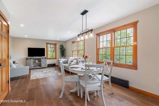 dining room featuring wood finished floors, baseboards, and recessed lighting
