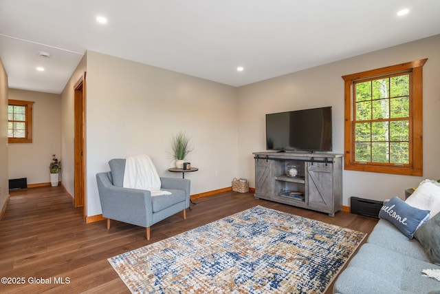 living room featuring wood finished floors, baseboards, and recessed lighting
