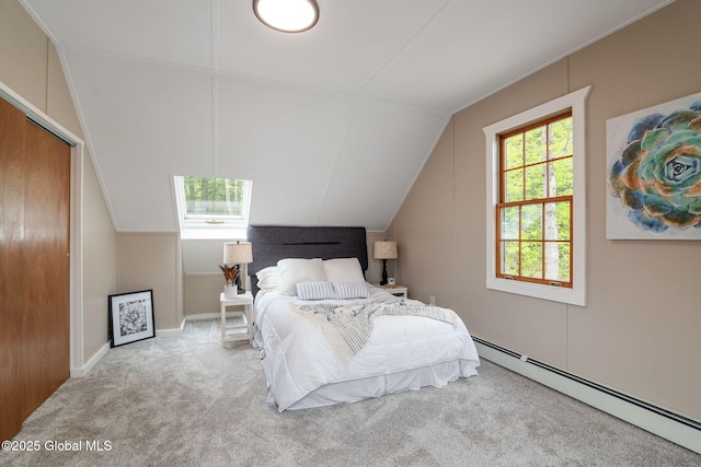 carpeted bedroom featuring baseboard heating, lofted ceiling, and baseboards