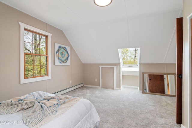 bedroom with a baseboard heating unit, carpet floors, lofted ceiling, and baseboards