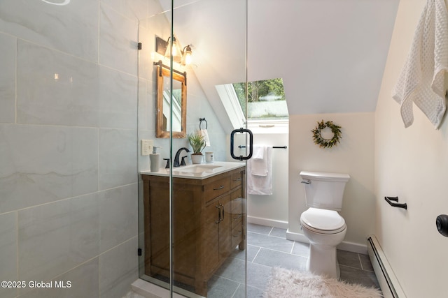 bathroom featuring a baseboard heating unit, vanity, toilet, tile patterned flooring, and baseboards