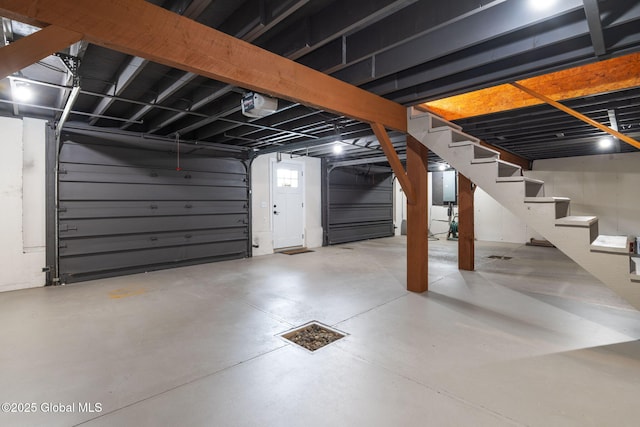 below grade area featuring stairway and a garage