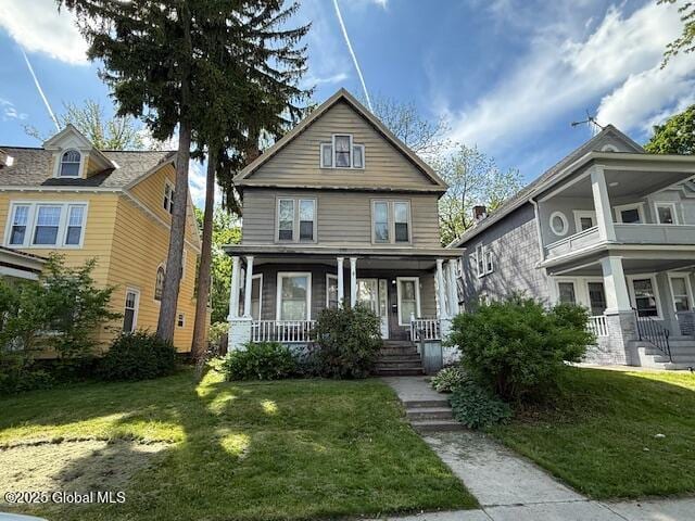 traditional style home with a porch and a front lawn