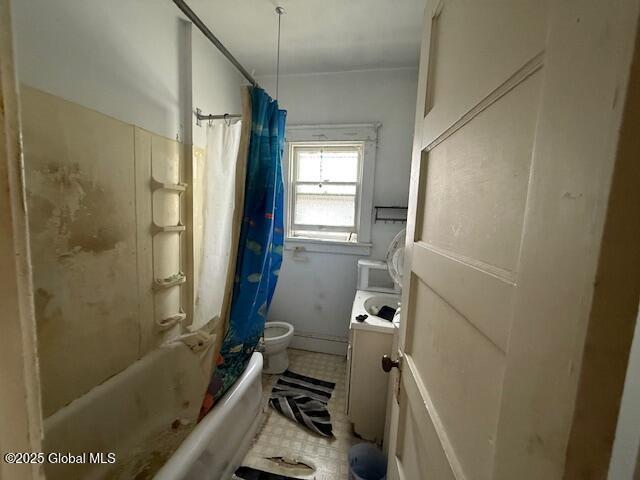 bathroom with shower / bathtub combination with curtain, toilet, and vanity
