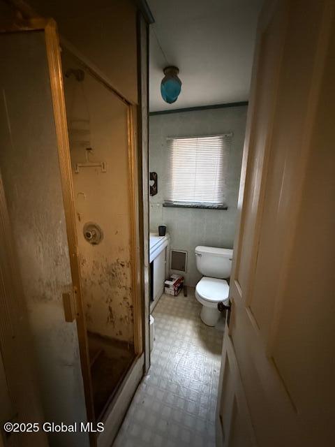 full bathroom with a shower stall, toilet, tile patterned floors, and vanity