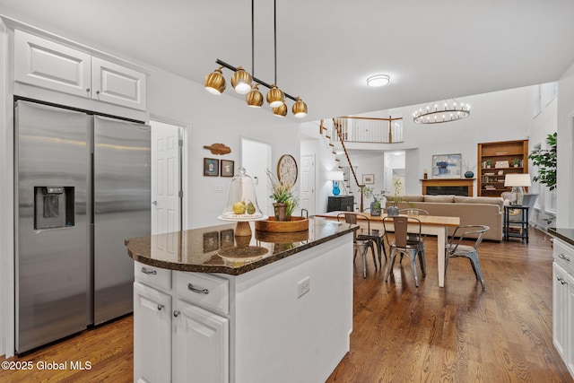 6004 Queen Mary Ct, Schenectady, NY 12303 - kitchen featuring stainless steel fridge, white cabinetry, dark stone counters, and dark wood-style flooring