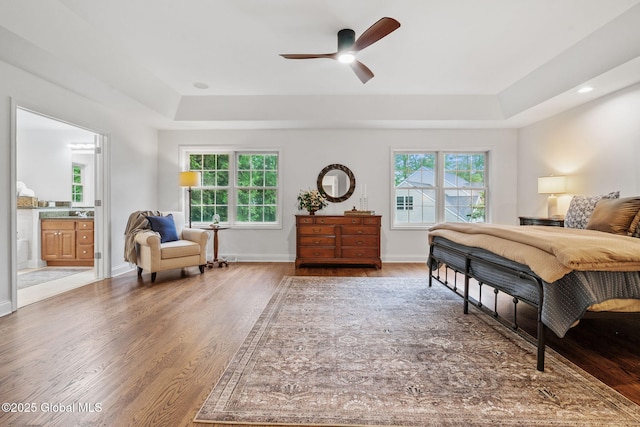 6004 Queen Mary Ct, Schenectady, NY 12303 - bedroom featuring a raised ceiling, wood finished floors, connected bathroom, baseboards, and a ceiling fan