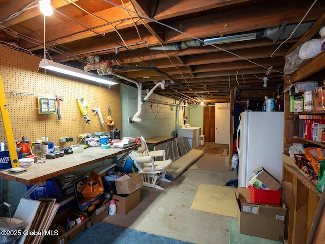 3 E St Stephens Ln, Glenville, NY 12302 - unfinished basement featuring a workshop area, freestanding refrigerator, and washer / clothes dryer