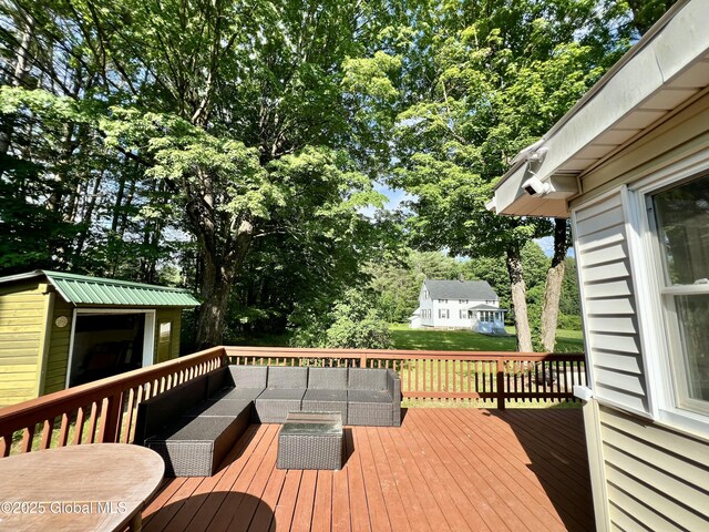 119 Houseman St, Mayfield, NY 12117 - wooden terrace featuring an outdoor hangout area, an outbuilding, and view of scattered trees