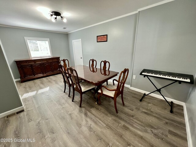 119 Houseman St, Mayfield, NY 12117 - dining space featuring ornamental molding, light wood-style flooring, and baseboards