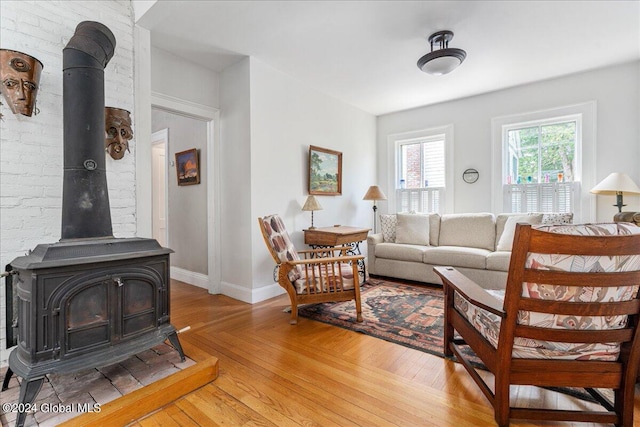 19 George St, Saratoga Springs, Inside, NY 12866 - living area with light wood-style flooring, a wood stove, and baseboards