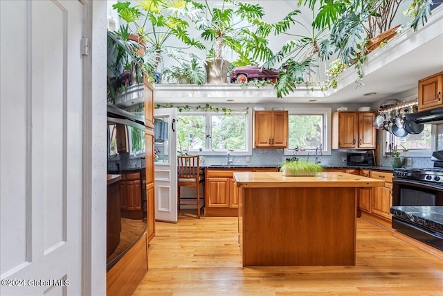 19 George St, Saratoga Springs, Inside, NY 12866 - kitchen featuring wooden counters, black microwave, a sink, tasteful backsplash, and a kitchen island