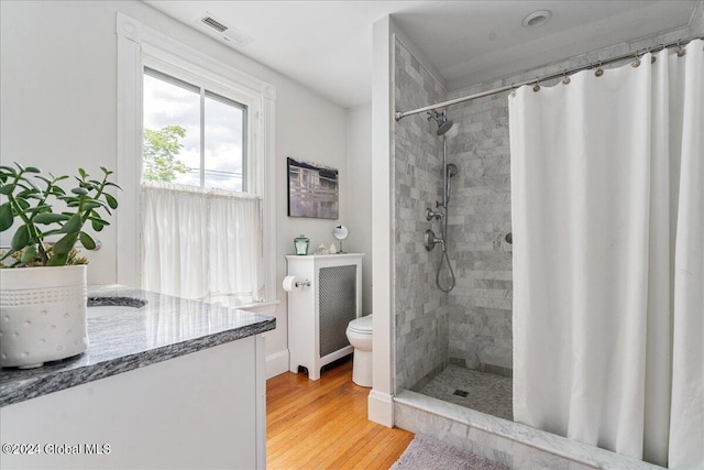 19 George St, Saratoga Springs, Inside, NY 12866 - bathroom featuring a tile shower, vanity, toilet, and wood finished floors
