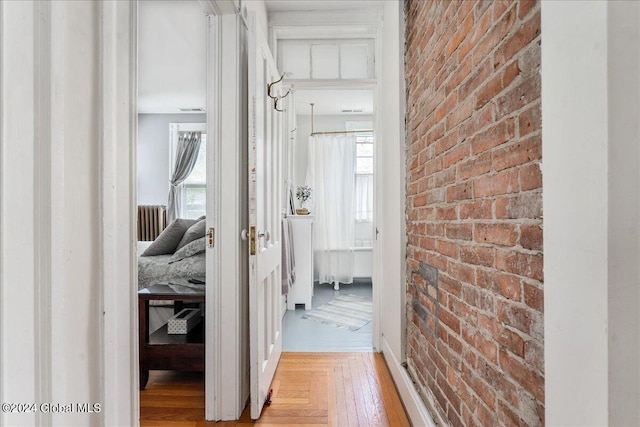19 George St, Saratoga Springs, Inside, NY 12866 - hall featuring brick wall, healthy amount of natural light, wood finished floors, and baseboards