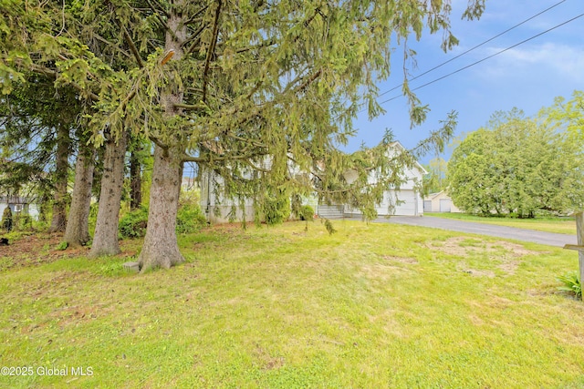 2188 Lynn St, Rotterdam, NY 12306 - view of green lawn with driveway and a garage