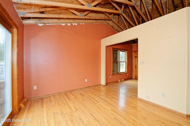 2188 Lynn St, Rotterdam, NY 12306 - empty room featuring light wood finished floors, plenty of natural light, and vaulted ceiling