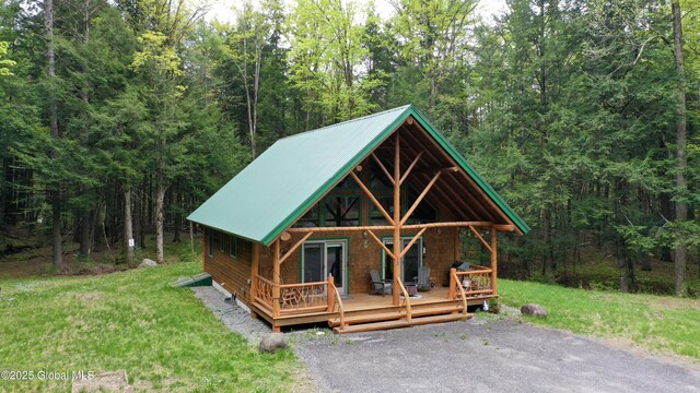 13 Dewey Rd, Chester, NY 12860 - view of front facade with a wooded view, metal roof, and a front lawn