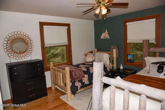 13 Dewey Rd, Chester, NY 12860 - bedroom featuring wood finished floors, multiple windows, and a ceiling fan