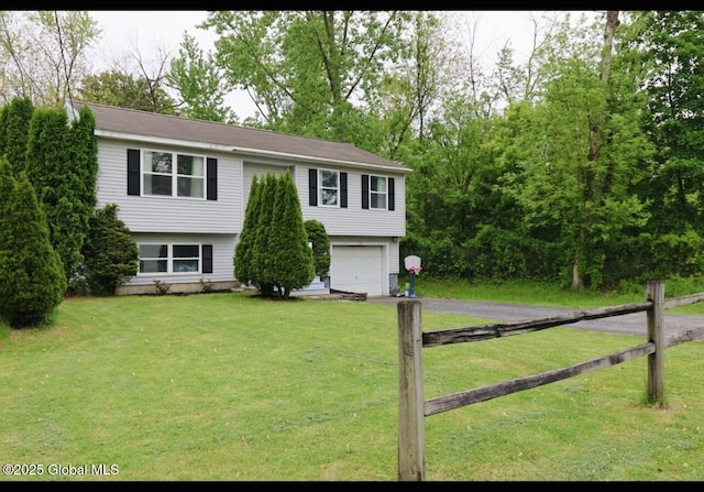 29 Clark St, Hudson Falls, NY 12839 - raised ranch with asphalt driveway, an attached garage, and a front yard