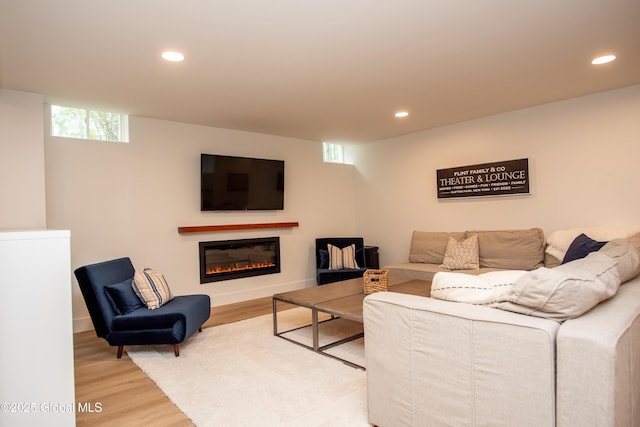 20 Bridgewater Ct, Clifton Park, NY 12065 - living area with light wood-type flooring, recessed lighting, a glass covered fireplace, and baseboards