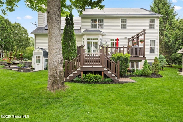 71 Hearthstone Dr, Wilton, NY 12831 - back of house featuring a wooden deck, a lawn, a chimney, and stairs