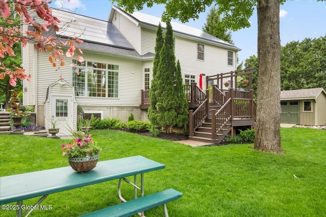 71 Hearthstone Dr, Wilton, NY 12831 - rear view of house with a yard, a wooden deck, solar panels, and stairway