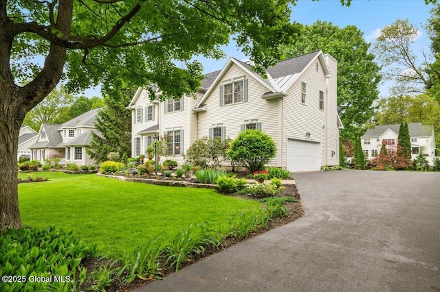 71 Hearthstone Dr, Wilton, NY 12831 - view of front of house with asphalt driveway, a garage, and a front lawn