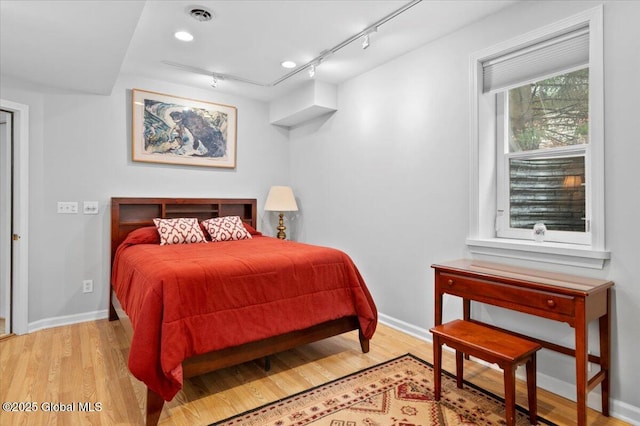 71 Hearthstone Dr, Wilton, NY 12831 - bedroom featuring track lighting, wood finished floors, and baseboards
