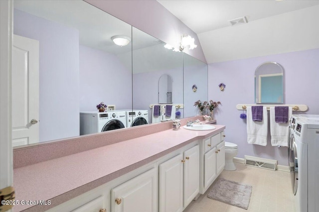 71 Hearthstone Dr, Wilton, NY 12831 - full bath with washing machine and dryer, vanity, toilet, vaulted ceiling, and baseboards