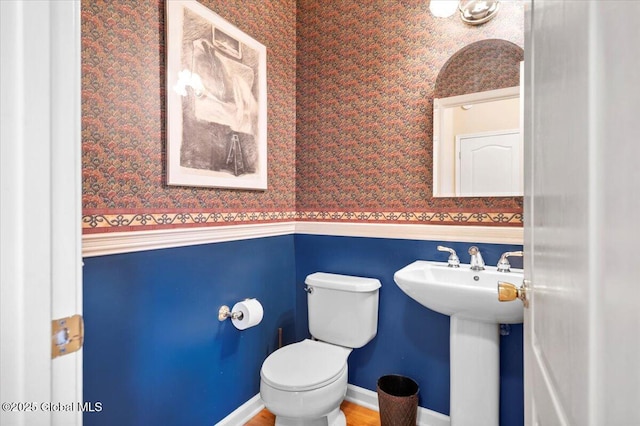 71 Hearthstone Dr, Wilton, NY 12831 - half bath featuring wallpapered walls, toilet, a sink, and wainscoting