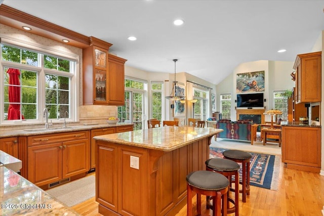 71 Hearthstone Dr, Wilton, NY 12831 - kitchen with a sink, light stone counters, plenty of natural light, brown cabinetry, and recessed lighting
