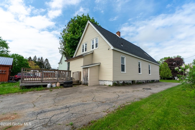 8 Rosewood Ave, Johnstown, NY 12095 - view of property exterior featuring a chimney, a deck, and a shingled roof