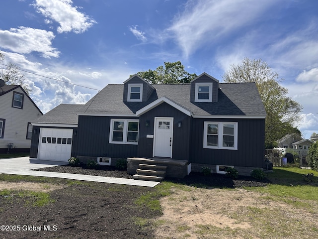 view of front of property featuring an attached garage, driveway, and roof with shingles