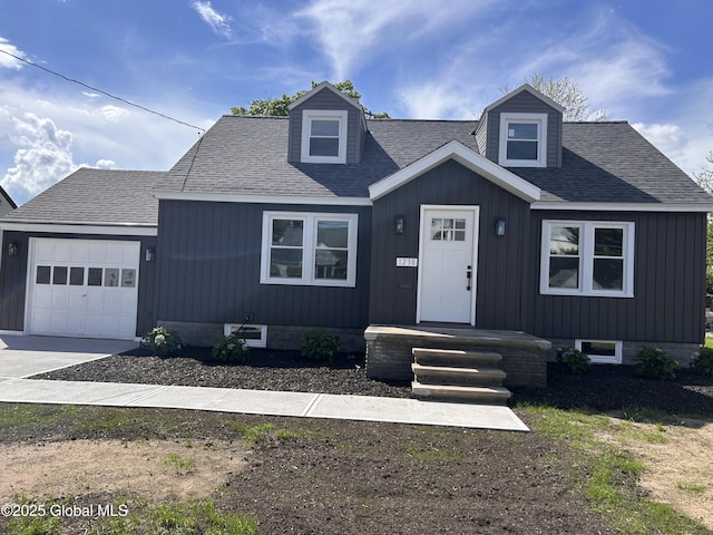 view of front facade featuring a garage, concrete driveway, and roof with shingles