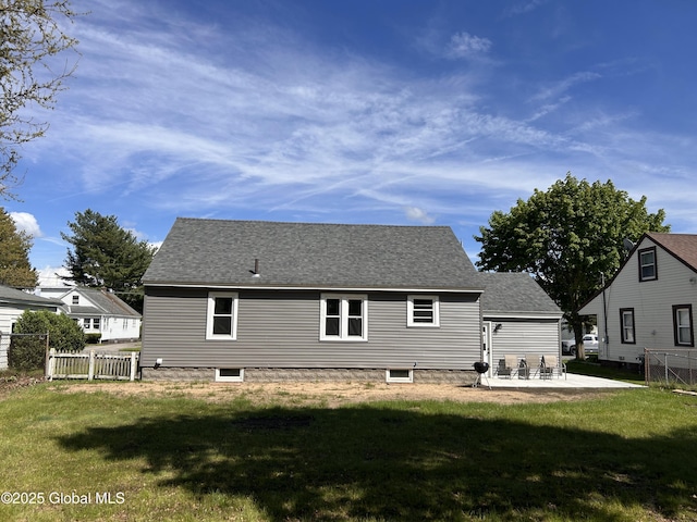 rear view of house with a patio and roof with shingles