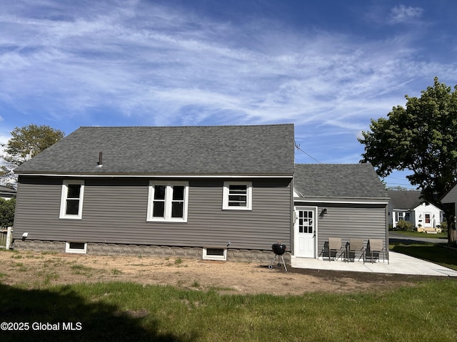 rear view of property featuring a patio area and roof with shingles