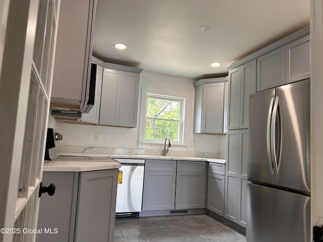 kitchen with freestanding refrigerator, gray cabinets, dishwasher, recessed lighting, and a sink