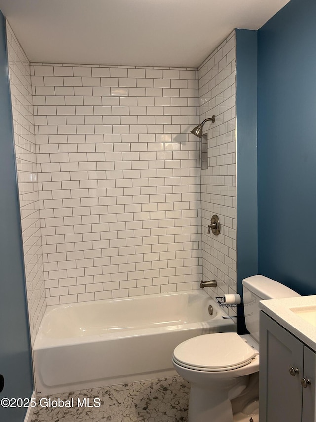 bathroom featuring toilet, vanity,  shower combination, and tile patterned floors